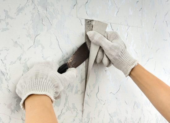 Removing,Old,Wallpapers,From,Wall,With,Spatula,During,Repair