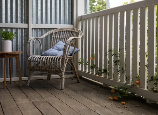 cozy-deck-with-rattan-chair-and-flowering-vines-2026-03-19-08-13-01-utc